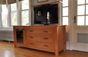 Wooden TV cabinet with lift feature.